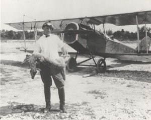 Photo of Fern standing in front of a single propeller plane