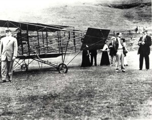 Historical photo of J.C. "Bud" standing next to his aircraft