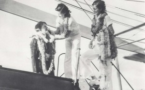 Mildred Mitchell presents a lei to Amelia Earhart while on an interisland tour of Hawaii, while her sister Bernice Mitchell waits with more leis, January 5, 1935.  