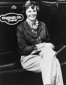 Amelia Earhart sits on the running board of a Standard Oil fueling truck, at Wheeler Field, 1935.