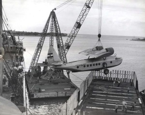 Inter-Island Airways. A Sikorsky S-43 is unloaded from a ship at Honolulu Harbor.
