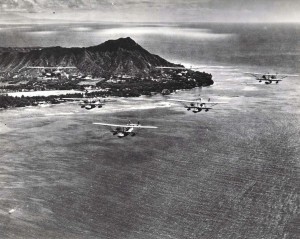 U.S. Navy bombing planes fly past Waikiki with Diamond Head in the background.