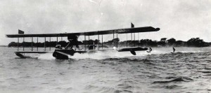 Water skiing behind an amphibian plane in Pearl Harbor, 1930s. 