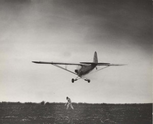 Crop dusting by airplane, Honolulu, 1930s. 