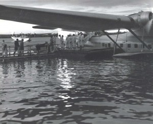 The first trans-Pacific air passengers boarding the Pan American Hawaii Clipper to continue their flight across the Pacific. In the background is the China Clipper.  