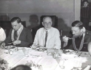 Clyde Panghorn, American flyer, Judge Walter F. Frear, former Governor of the Territory, and Roscoe Turner, American flyer, at a dinner honoring Pangborn and Turner who arrived in Hawaii on November 26, 1934 after finishing second in the London to Melbourne Air Derby. Their Boeing plane was carried on a ship to Hawaii.   