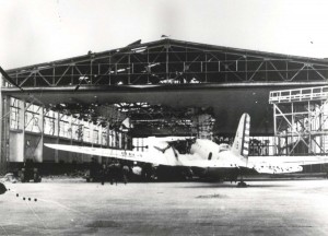 A B-18 belonging to 11th Bombardment Group outside of wrecked hangar at Hickam Field, December 7, 1941.   