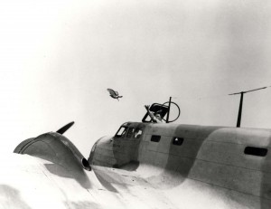 Lt. Herschel Chenoweth, commander of Pigeoneers at Hickam Field, tosses bird from hatch of a B-18 bomber 3,000 feet in the air during an observation flight over Hawaii, January 1943. 
