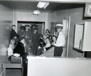 Passengers and crew await processing through U.S. Immigration Services, Honolulu International Airport, 1950s. 