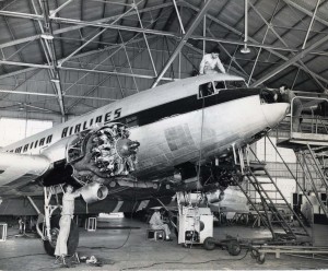 Mechanics work on a Hawaiian Airlines engine. 