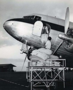 Air mail is loaded onto a Hawaiian Airlines plane at Honolulu International Airport, 1950s.