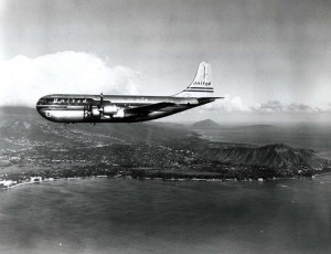United Air Lines Mainliner cruises past Waikiki, 1950s. 