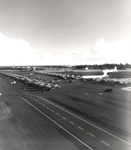Hickam Air Force Base, Hawaii, flight line in 1960s during Vietnam War. Fort Kamehameha trees are shown at right.  