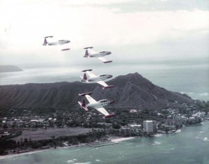 T-33A Shooting Star aircraft of the 15th Air Base Wing, Hickam Air Force Base, Hawaii, fly past Waikiki Beach, 1982.  