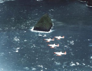 T-33A Shooting Stars from Hickam Air Force Base, Hawaii, fly in formation over Black Rock, 1982.  