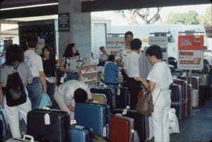 Travelers exit International Arrivals Building into Group Tour Area, Honolulu International Airport, 1990s.  
