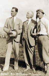 Dole Derby pilots Art Goebel, left, and Martin Jensen, right, with Governor Wallace R. Farrington, at Wheeler Field, August 17, 1927.