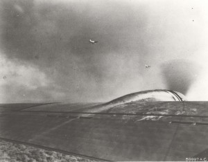 Two Japanese aircraft were photographed over Hickam Field by crew members of one of 12 B-17s that arrived from California in middle of attack. This is one of first photos of December 7, 1941 attack. 
