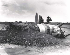 Gun emplacement in front of Hangar 5 at Hickam Field, built with a burned out aircraft engine, table, sand bags and debris, December 7, 1941. 