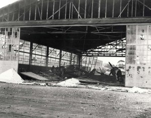 Wrecked hangar with destroyed planes at Wheeler Field, December 7, 1941.