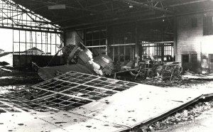 Severely damaged P-36 sits in wrecked hangar at Wheeler Field, December 7, 1941.
