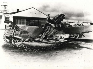 Warhawk wreck in front of Hangar 4 at Wheeler Field, December 7, 1941. Several P-40s and P-36s got airborne during the attack and destroyed nine enemy aircraft in air-to-air combat.