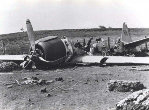 Historic photo of a damaged aircraft on Hickam Field taken in 1941