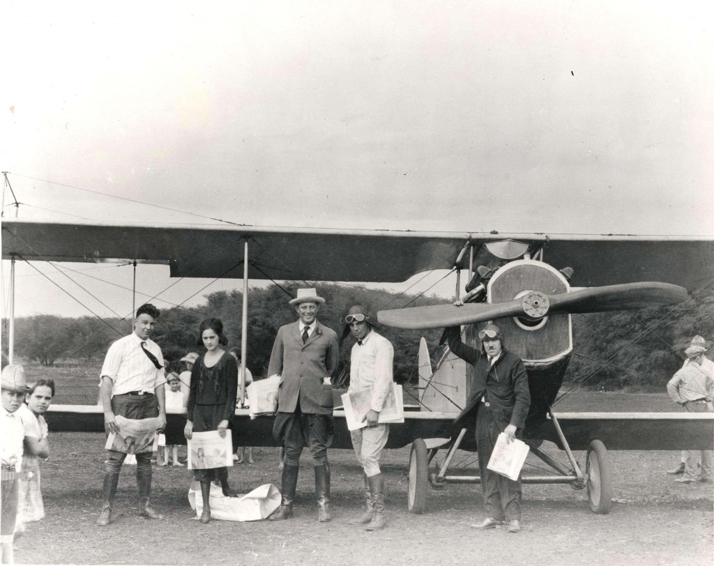Photo of Charles Fern standing in front of a single propeller plane