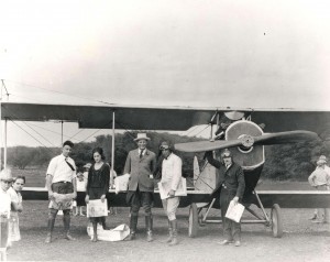 Photo of Charles Fern standing in front of a single propeller plane