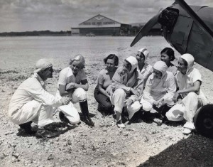 Historic photo of individuals in front of a single engine aircraft