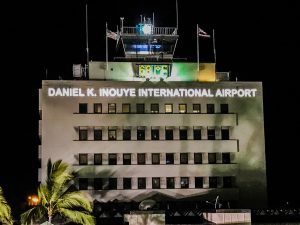 The new Daniel K. Inouye International Airport sign on the Airports Division District Office Tower is black during the day and illuminates white at night. The picture shows the mauka side of the building. Photo courtesy: HDOT