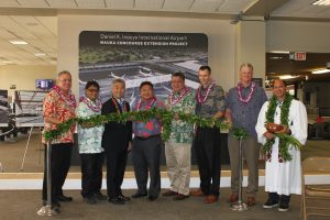 Airlines Committee of Hawaii Co-Chair Blaine Miyasato (from left to right), House Vice Speaker Mark Nakashima, Governor David Ige, HDOT Director Jade Butay, Senate President Ronald Kouchi, Hawaiian Airlines President & CEO Peter Ingram, Hensel Phelps Vice President Thomas Diersbock, and Kahu Kordell Kekoa participate in the untying of the maile lei during the groundbreaking ceremony for the Mauka Concourse project.