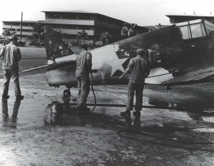Ground crew members wash P-40 aircraft fuselage at Hickam Field, 1940.