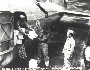 Loading blackout leaflets on B-18 at Hickam Field for distribution on Oahu, May 18, 1940.