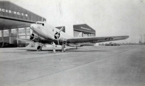 C-39 aircraft with 6th Fighter Squadron emblem in front of hangars at Hickam Field, c1940.