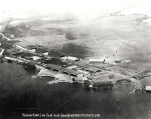 Luke Field on Ford Island with DH-4 and JN-4/6 aircraft lined up. At lower left are aircraft packing crates. Round spot on field is compass rose, c1919-1921.     