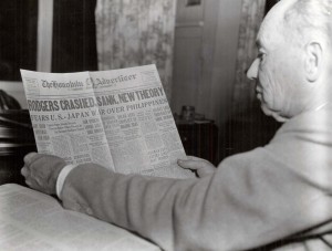 Pilot B. J. Connell reads an article about the plane and crew presumably being lost at sea in the Honolulu Advertiser on the 50th anniversary of the flight.