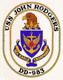 This is the official crest of John Rodgers which symbolizes the service of three members of the prominent Navy family. The anchor represents Commodore John Rodgers who was President of the Board of Naval Commissioners following the War of 1812 until 1836. His son, Rear Admiral John Rodgers led exploring expeditions in Chinese waters and throughout the Baring Strait in 1855; the compass rose is symbolic of his service. Commander John Rodgers II, great grandson of Commodore Rodgers, was a pioneer of naval aviation, and his service is alluded to by the wings  