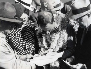 Charles Kingsford Smith signs the customs manifest at Wheeler Field after his arrival from Fiji, October 29, 1934. 