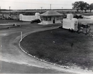 Wings at the entranceway flanking the gatehouse of Hickam Field were in place in 1937 but not yet painted and a perimeter fence had been installed. The original concrete gate portals still remain today, and were moved back to their present location in April 1978.  