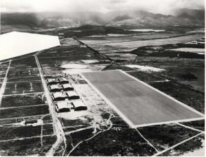 Work was completed on four double hangars, a paved 800 x 3,000-foot landing mat, dock, boathouse and mole, sewer system, fresh water system, radio building, operations building with a fenced magazine area, railroad and parallel highway by July 21, 1937. Navy censors blocked out Pearl Harbor.  