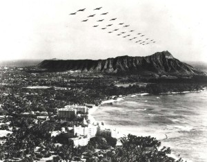 Trick photo; not authentic. Created by combining 1-18-1934 photo of Waikiki and April 6, 1940 photo of B-18 formation over Oahu.