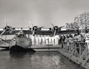 Patricia Kennedy, in the bow of plane, christens the Pan American Hawaii Clipper with coconut water, at Pearl Harbor. May 1936  