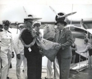 First official consignment of federal mail when R. O. H. Sullivan, executive officer of the Pan American Clipper turned over the government bags to John H. Wilson, U.S. Postmaster at Honolulu 18 hours after the mail was dispatched in California.  