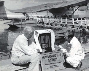 RCA Victor radio set arrives at Honolulu on Pan American Clipper. W H Stone, Mutual Telephone Co. & RCA distributor, and J A Brooks, PAA employee unload the set.