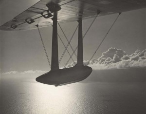 Sunset in the American tropics as Pan American's U.S. mail plane wings into Honolulu, 1930s.