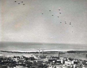 U.S. Army Air Corps December 21, 1934. U.S. service planes in formation over Honolulu honoring the Wright Brothers. The planes later flew out to sea and dropped leis in memory of Capt Charles Ulm and his companions who died attemping to fly beween California and Australia.  