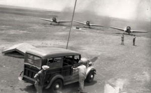 P-36s from Wheeler Field taxiing to gas pit at Morse Field, Hawaii, to refuel. Shown is a 1934 Chevy station wagon. The small roof covered the gas system segregation, 1941. 