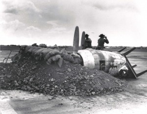 Gun emplacement in front of Hangar 5 at Hickam Field, built with a burned out aircraft engine, table, sand bags and debris, December 7, 1941.   