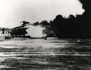 Smoke billows from burning B-17 on Hickam Field flight line, December 7, 1941.   